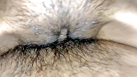 Hairy girl takes off clothes and fingering hairy pussy