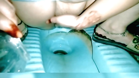 Amateur brunette with big tits has fun in the toilet