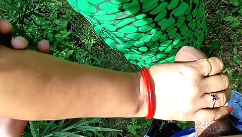 Brunette girl is doing a hardcore handjob on the ground