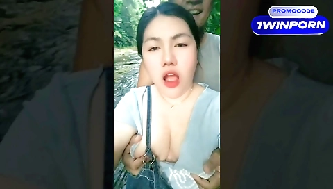 Hot brunette is outdoors and she is playing with her hair