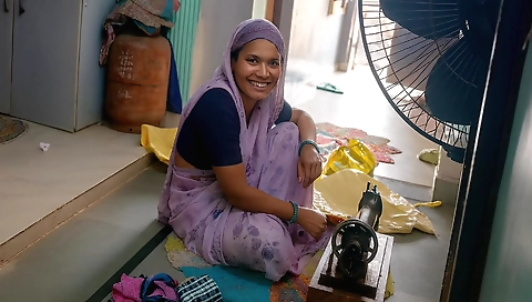 Indian girl shows her handcraft skills using her sewing machine