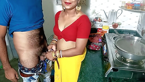 A brunette maid girl doing a handjob in the kitchen